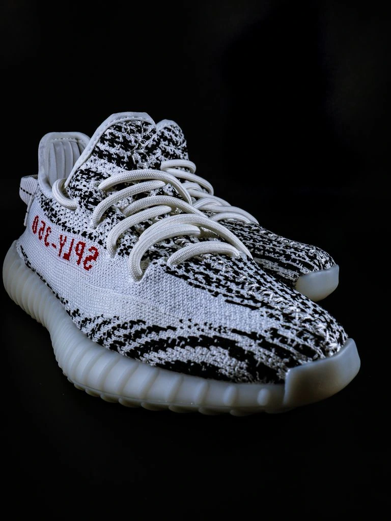 Bone-colored adidas Yeezy Slide on cream background